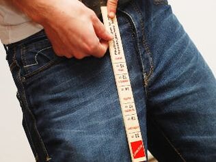 A man measuring the length of his penis