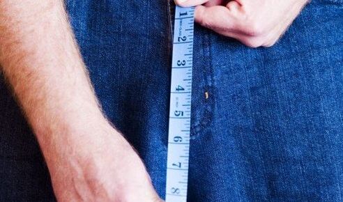 The person measures the length of the penis
